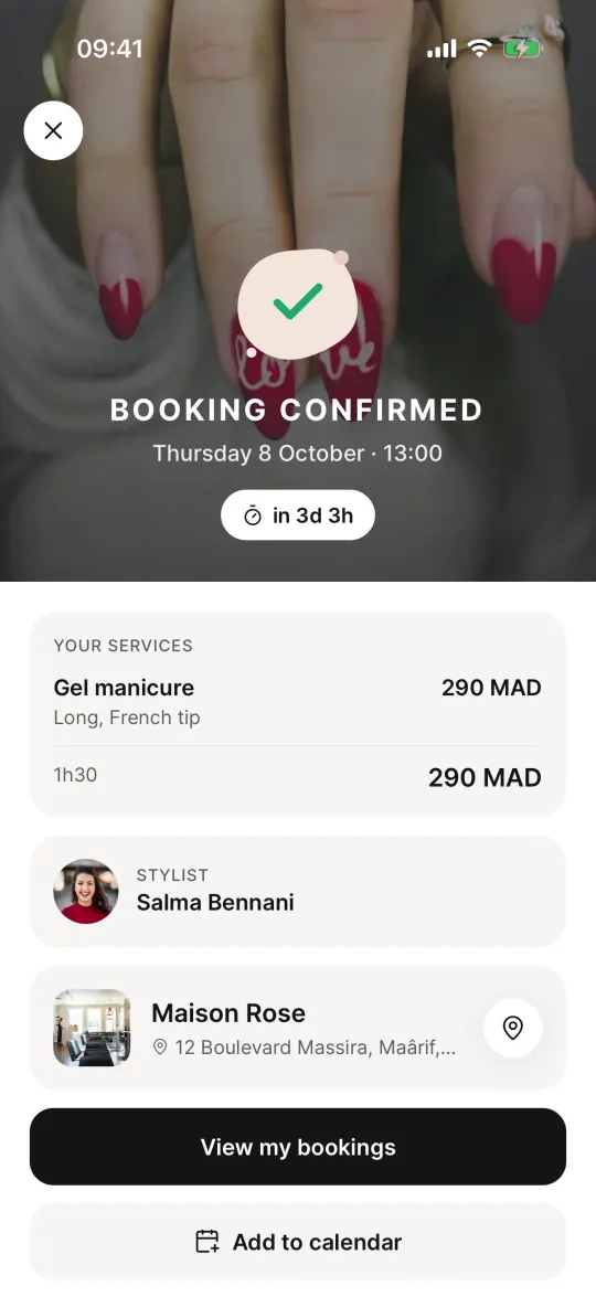 The booking is confirmed, with the salon, stylist and price